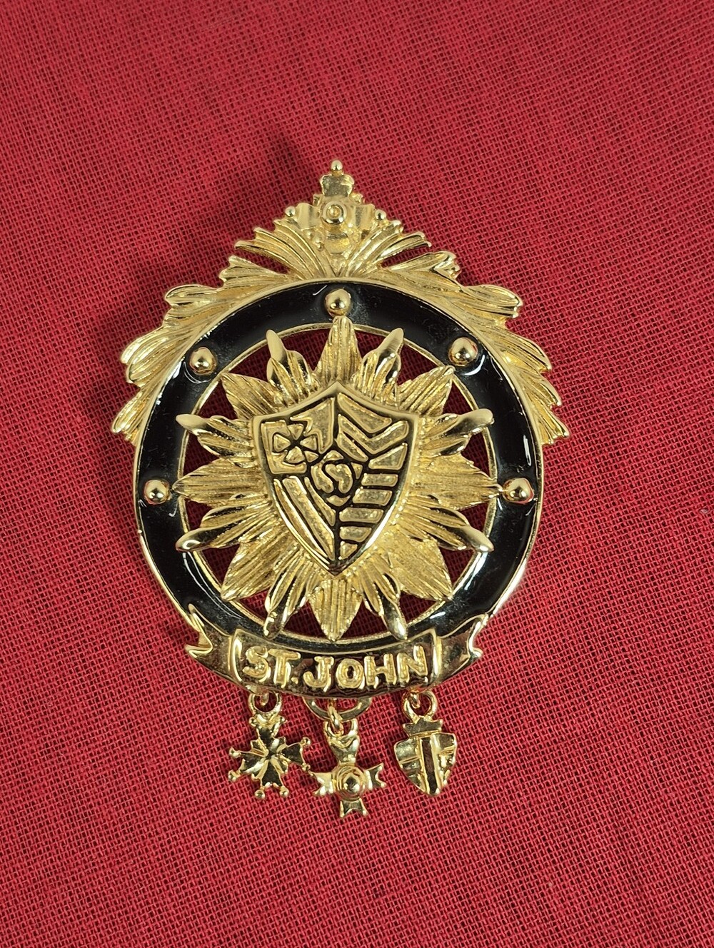 Vintage St. John Gold-Tone Crest Brooch w/Black Enamel & Dangling Charms